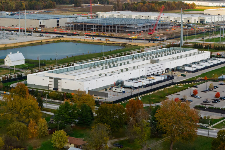Aerial view of a large AI data center complex under construction,