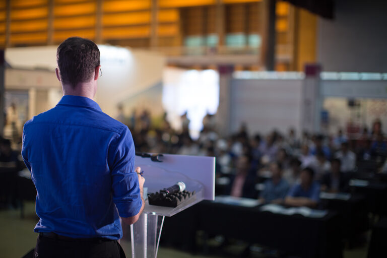 Man presenting to an audience seeking SBIR and STTR funding