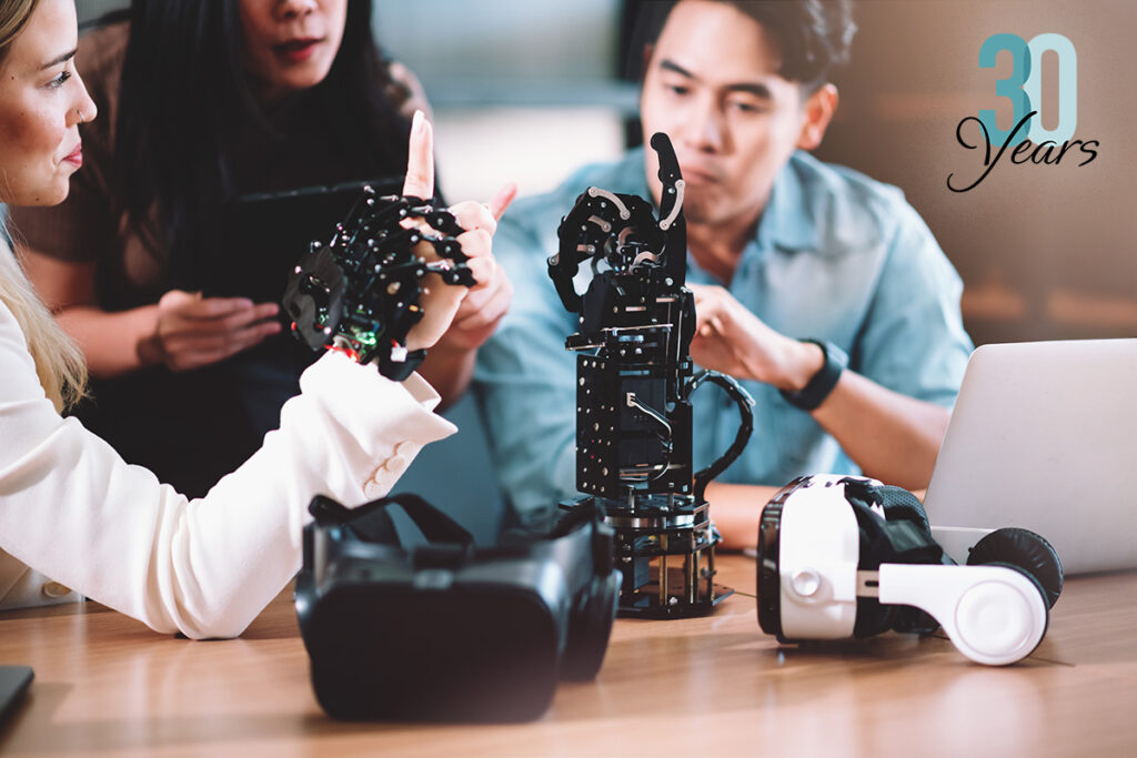 Engineers working on a robotic arm - Innovation